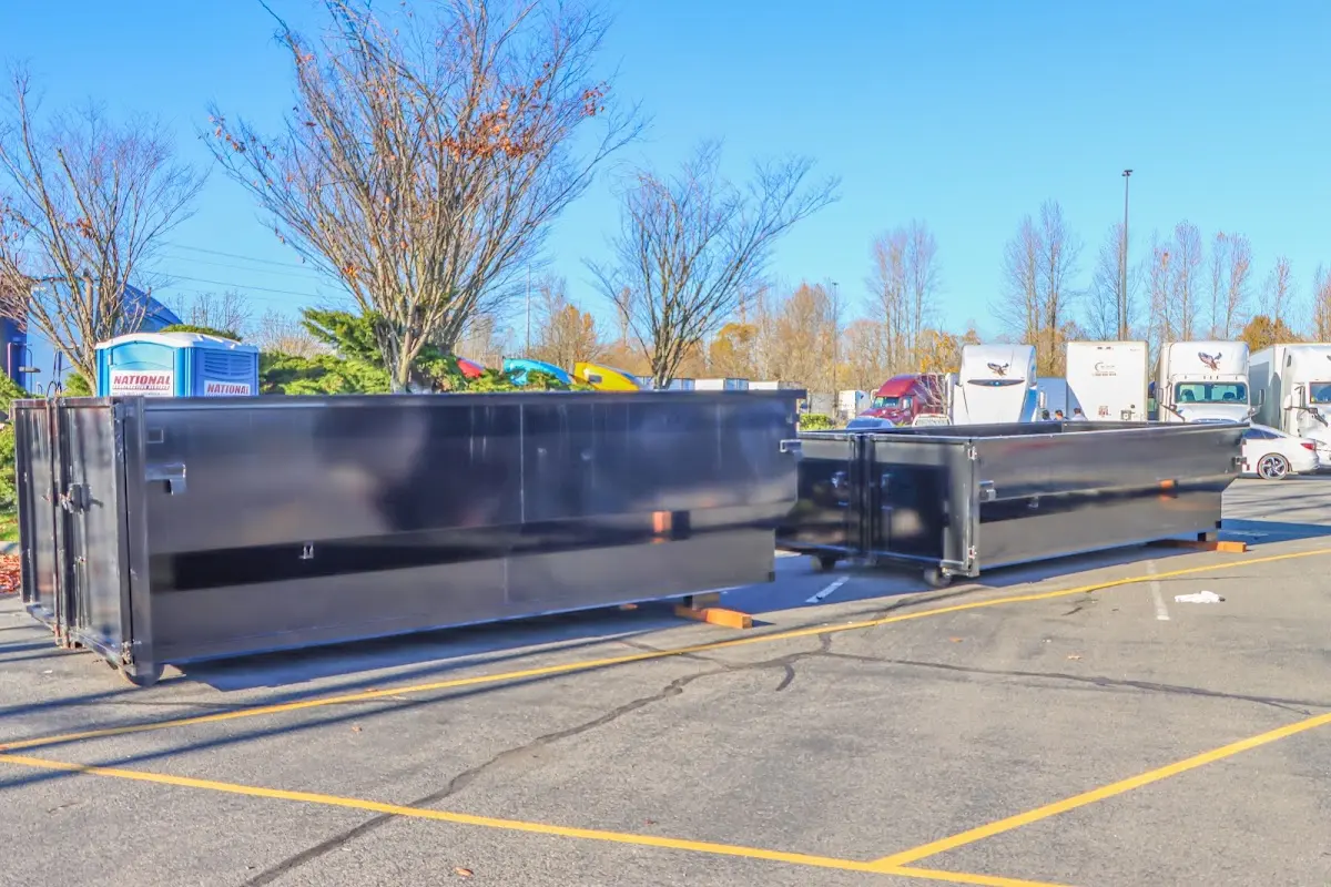 Professional dumpster rental service with roll-off container on residential driveway in Pigeon Forge